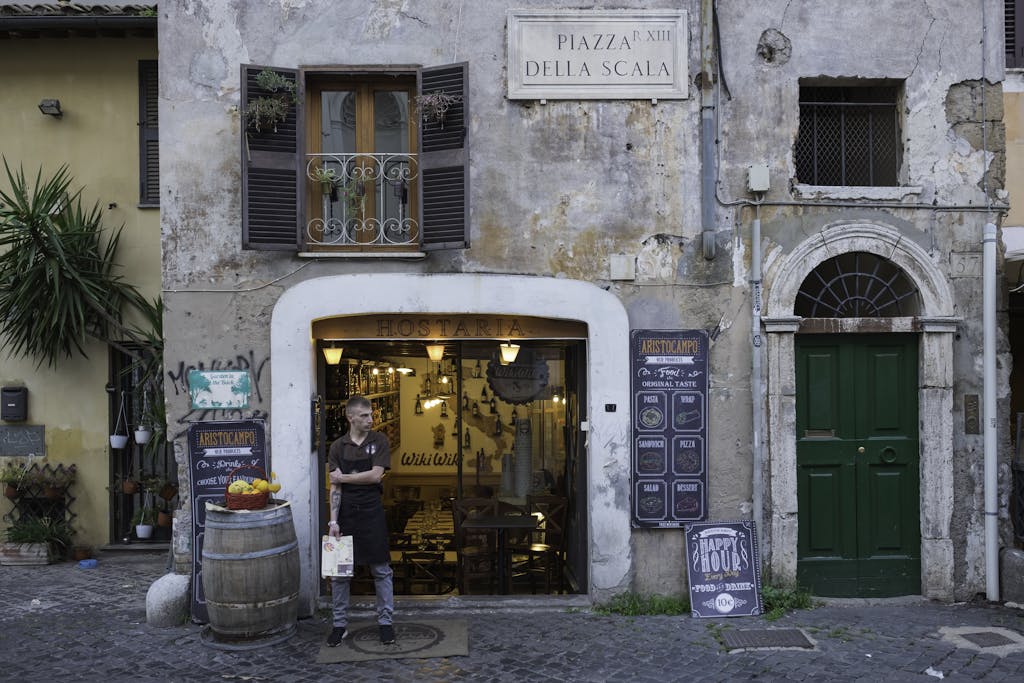 Rustic restaurant entrance in Trastevere, Rome, capturing Italian street charm.