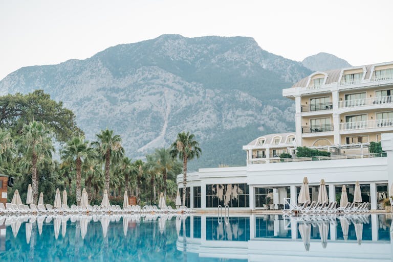 Tranquil luxury hotel paradise with mountain backdrop and inviting poolside setting.