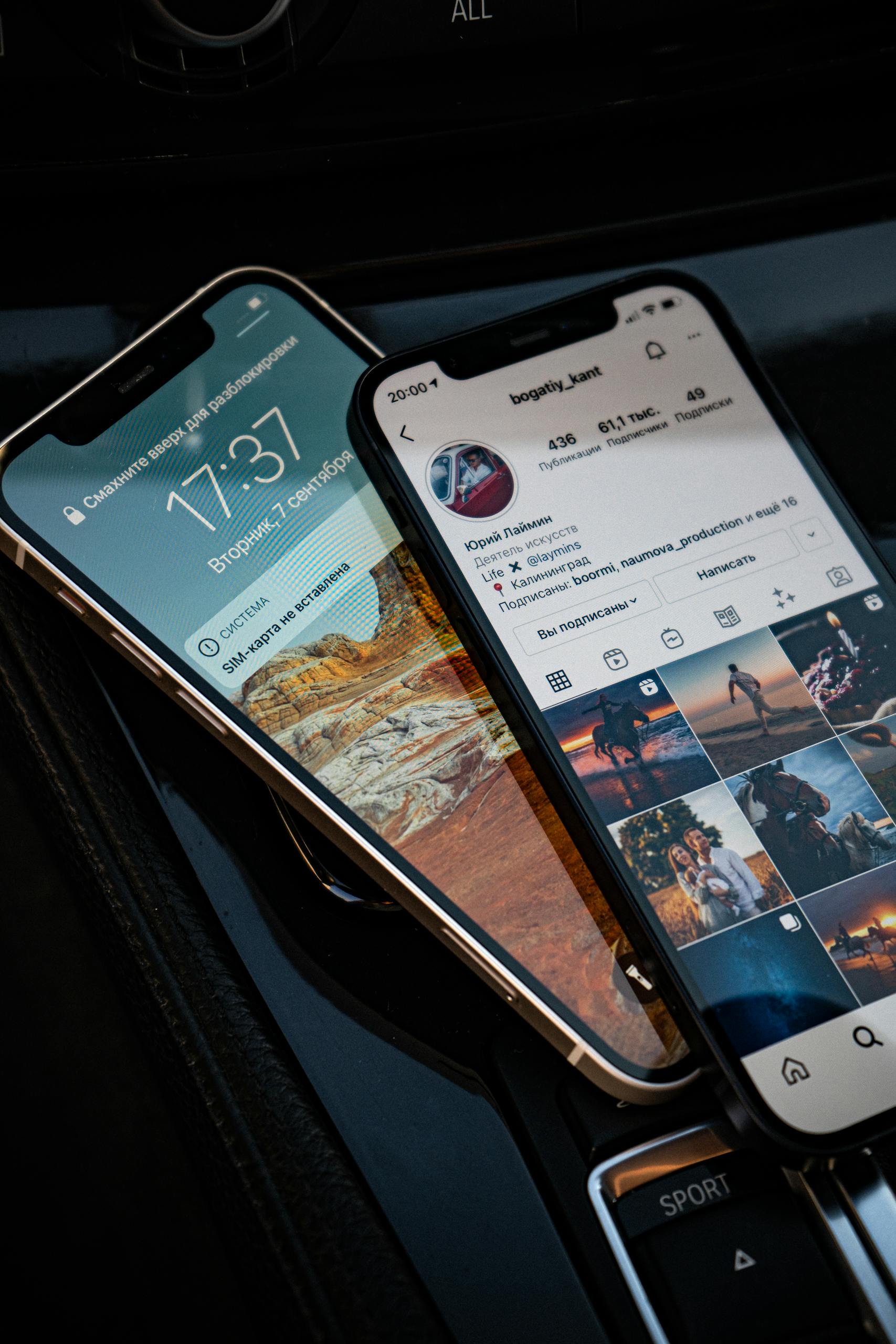 Close-up of two smartphones showing social media and lock screen in a car setting.